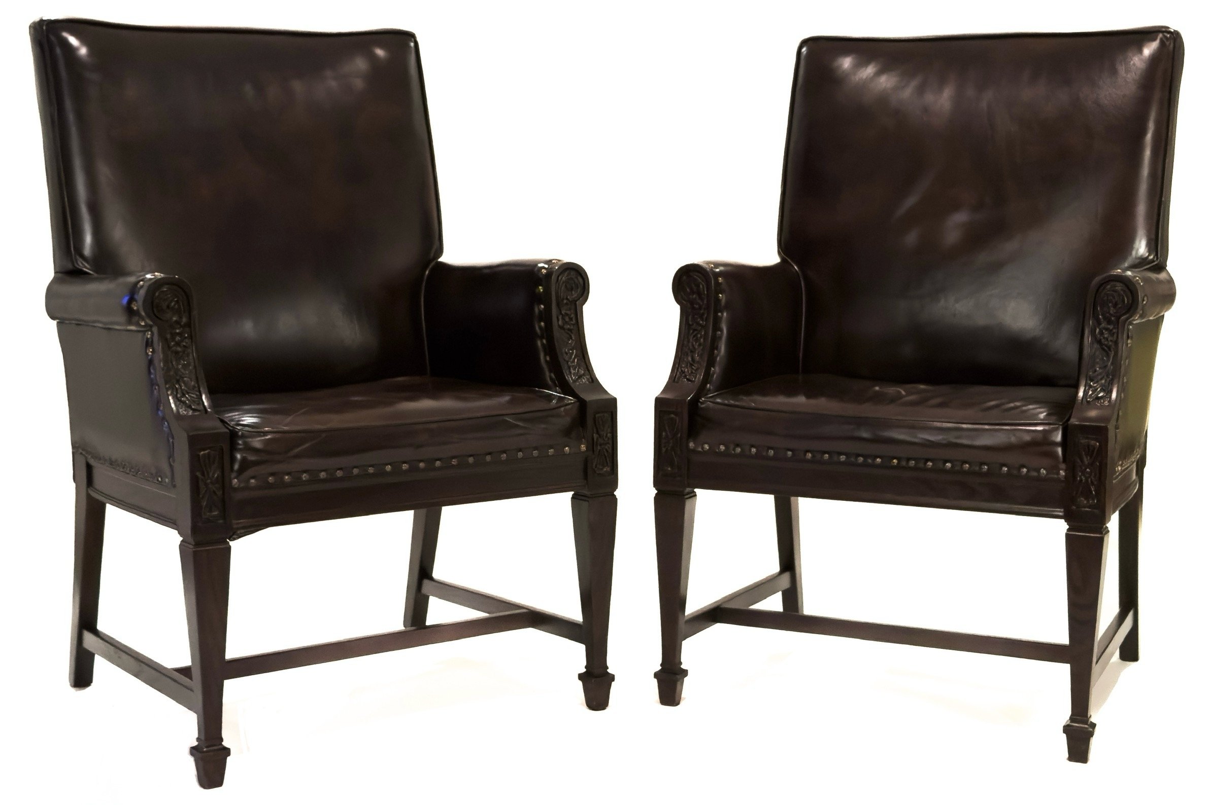 Pair of carved Romweber leather armchairs, front view